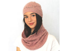 Load image into Gallery viewer, A young woman faces the camera. She has long dark hair and a white shirt is wearing a dusky pink lacey beanie and cowl. The background is white.
