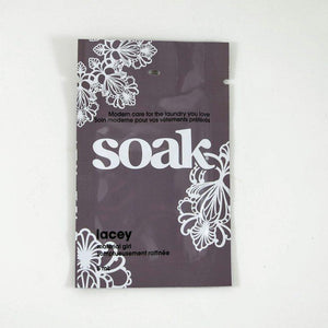 One dark grey sachet of Soak rinse-free laundry liquid on a white background (Lacey scent)