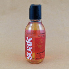 Load image into Gallery viewer, One small bottle of Soak rinse-free laundry liquid with a dark pink label, on a tan background (Celebration scent)

