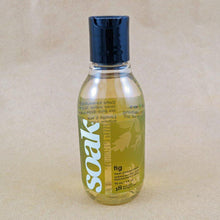 Load image into Gallery viewer, One small bottle of Soak rinse-free laundry liquid with a green label, on a tan background (Fig scent)