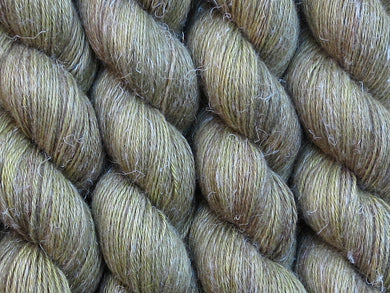 A close up of semi-solid mid-khaki green with hints of brown, chartreuse and golden tan coloured skeins of non-superwash baby alpaca, silk and linen 4ply fingering weight yarn (Fatigued on Spinifex)