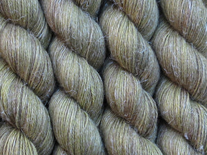 A close up of semi-solid mid-khaki green with hints of brown, chartreuse and golden tan coloured skeins of non-superwash baby alpaca, silk and linen 4ply fingering weight yarn (Fatigued on Spinifex)