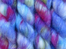 Load image into Gallery viewer, A close up of variegated blues, magenta, white and yellow green coloured skeins of superfine kid mohair and silk 2ply lace yarn (Rhelma on Kid Glove Lace)
