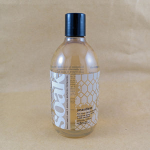One large bottle of Soak rinse-free laundry liquid with a white label, on a tan background (Scentless)