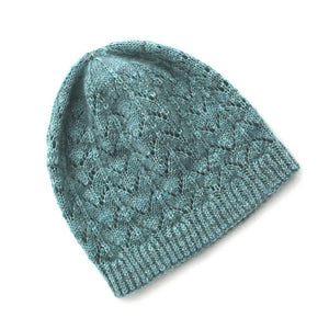 A pale blue-green fishtail lace beanie sits on a white background.