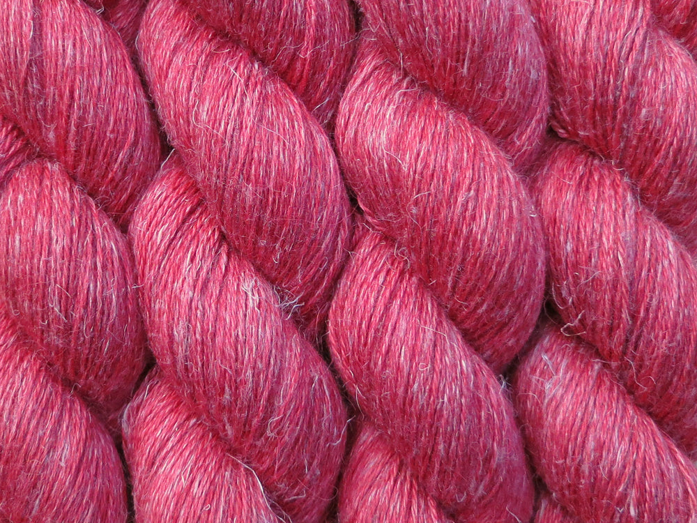 A close up of semi-solid red with hints of maroon and crimson coloured skeins of non-superwash baby alpaca, silk and linen 4ply fingering weight yarn (Japonica on Spinifex)