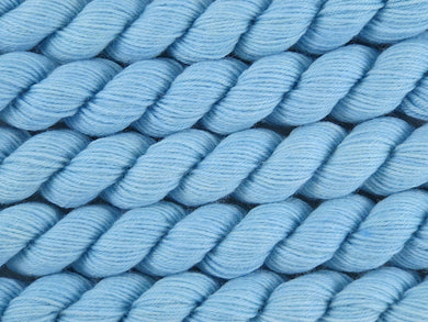 A close up of semi-solid light clear blue leaning towards aqua mini skeins of superwash merino and nylon 4ply fingering sock yarn arranged horizontally (Little Boy Blue on Tough Stocking Mini)