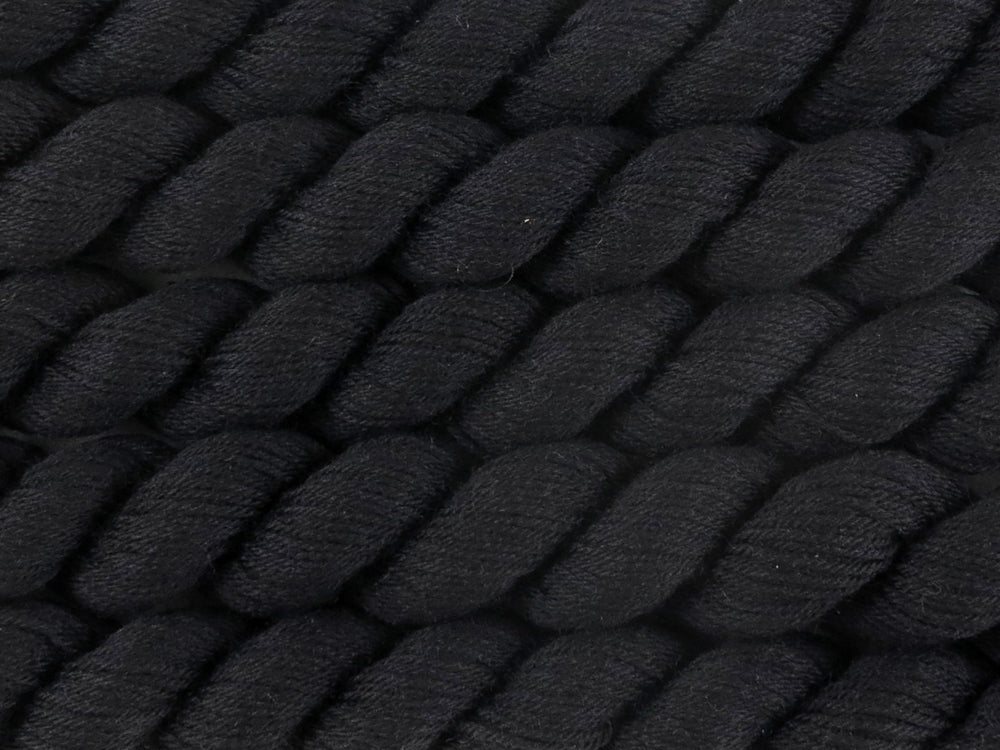 A close up of almost solid black mini skeins of superwash merino and nylon 4ply fingering sock yarn arranged horizontally (Pitch Black on Tough Stocking Mini)