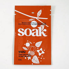 Load image into Gallery viewer, One dark orange sachet of Soak rinse-free laundry liquid on a white background (Yuzu scent)
