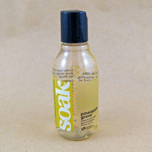 Load image into Gallery viewer, One small bottle of Soak rinse-free laundry liquid with a yellow label, on a tan background (Pineapple Grove scent)
