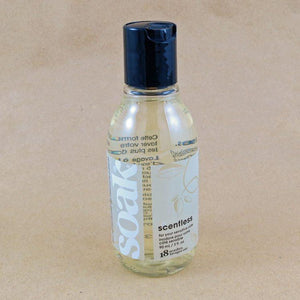 One small bottle of Soak rinse-free laundry liquid with a white label, on a tan background (Scentless)
