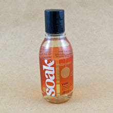 Load image into Gallery viewer, One small bottle of Soak rinse-free laundry liquid with an orange label, on a tan background (Yuzu scent)
