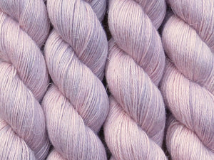 A close up of semi-solid dusty pink with hints of mauve and grey coloured skeins of non-superwash baby alpaca, silk and linen 4ply fingering weight yarn (Vintage Rose on Spinifex)